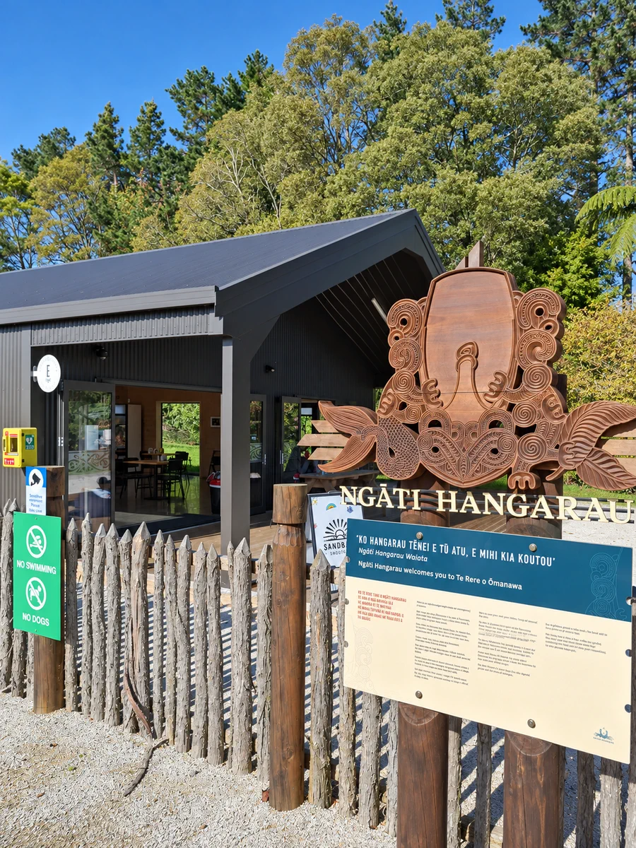 Omanawa Cafe beside the carved entrance at Te Rere o Ōmanawa